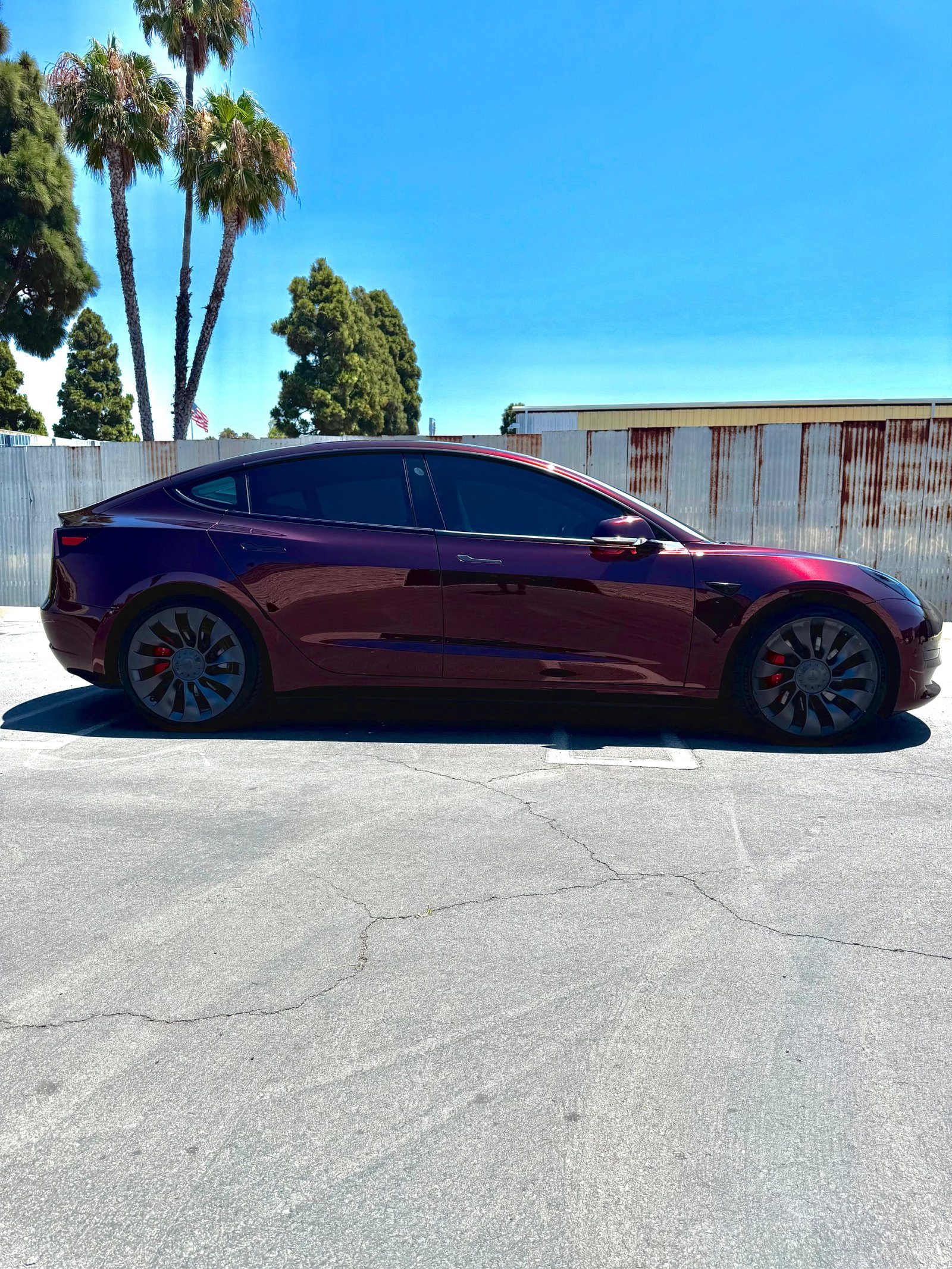 Tesla Model 3 with a deep red color-change wrap by WrapFX San Diego