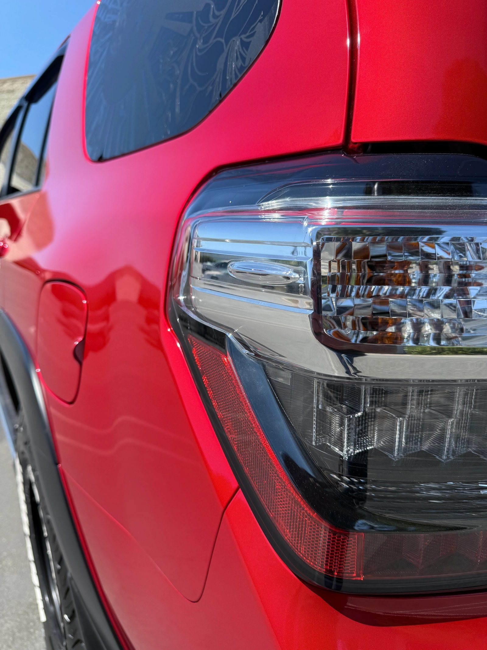 Seamless red vinyl wrap finish around a Toyota 4Runner taillight